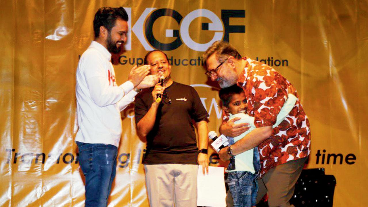 Actor Boman Irani hugs a child at the hospital, as (extreme left) Dr Karan Gupta and (middle) Deepak S Bhatia look on