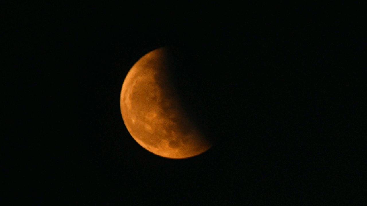 Moon partially covered by the earth's shadow during Lunar Eclipse in Patna. Pic/ PTI
