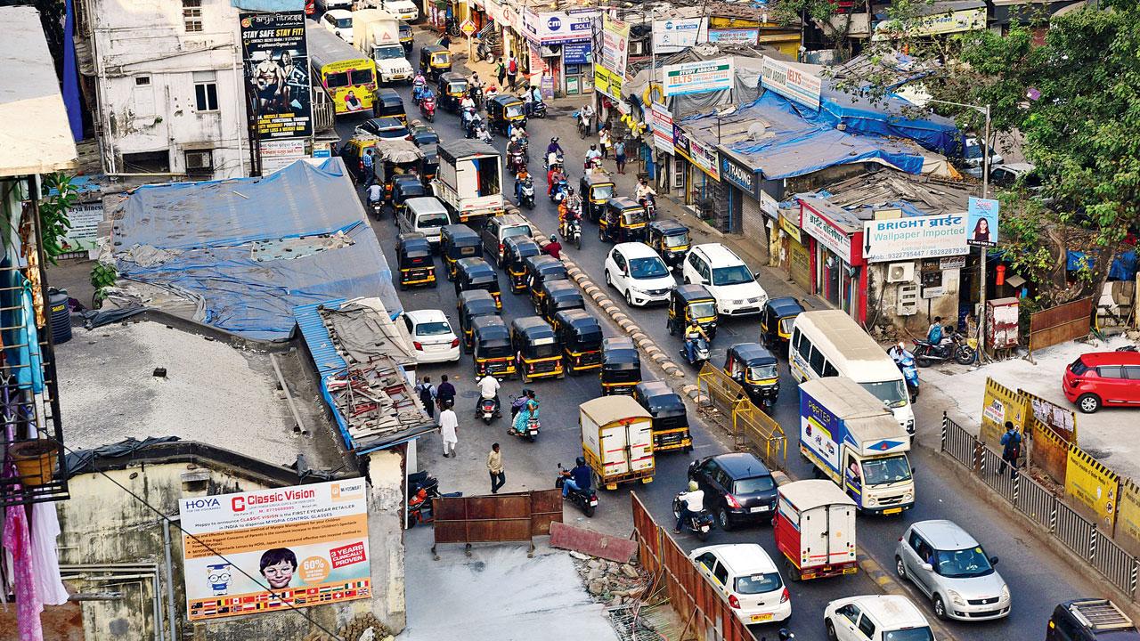 The BMC is struggling to get the shops on the right, near a nullah in Malad, removed. Pic/Nimesh Dave