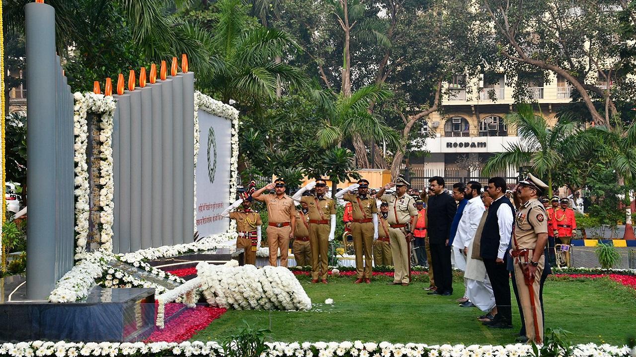 Maharashtra Chief Minister Eknath Shinde with Dy CM Devendra Fadnavis pays homage at the Police Memorial on the occasion of the 14th anniversary of the 26/11 Mumbai terror attack Pic/PTI