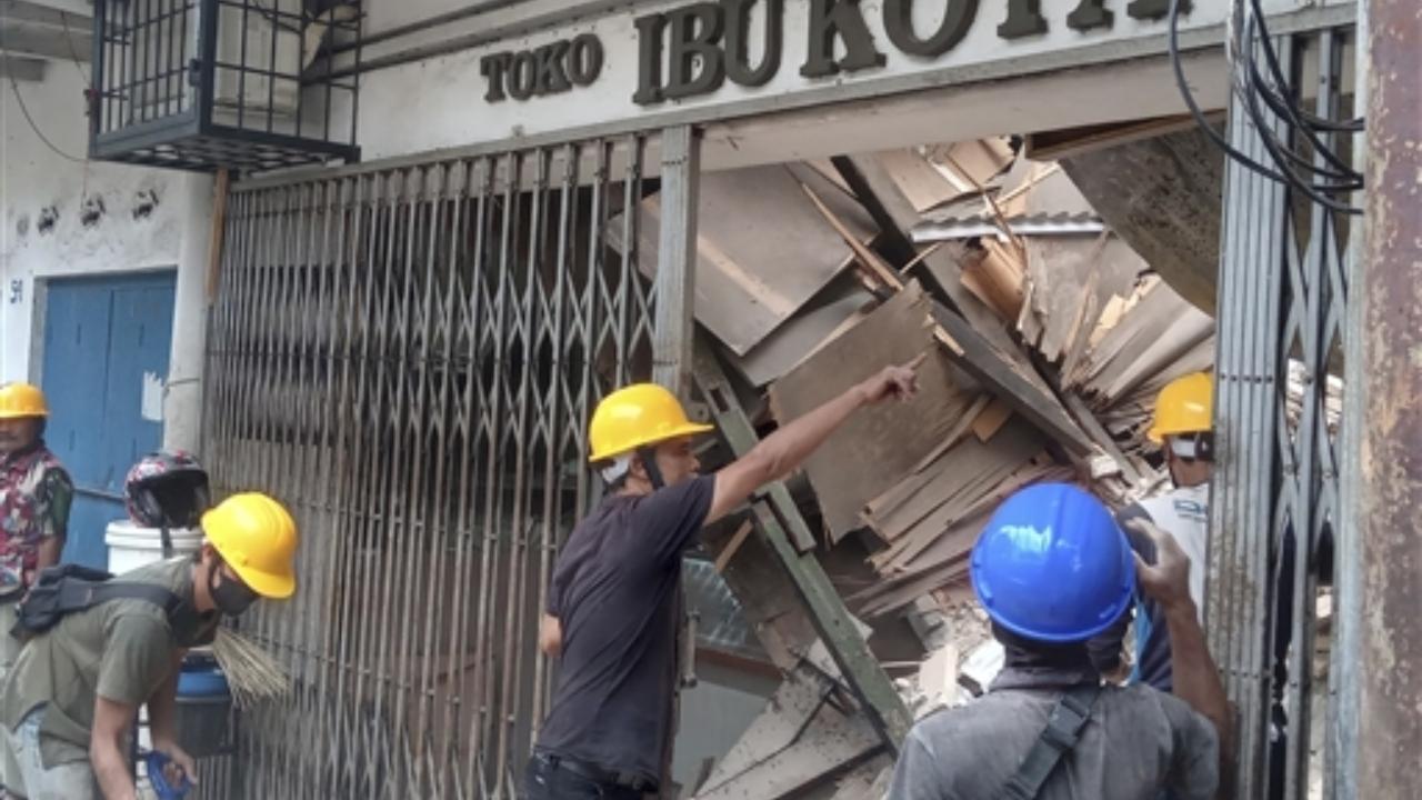 Workers inspect a store damaged during the earthquake in Cianjur, West Java, Indonesia on Monday.