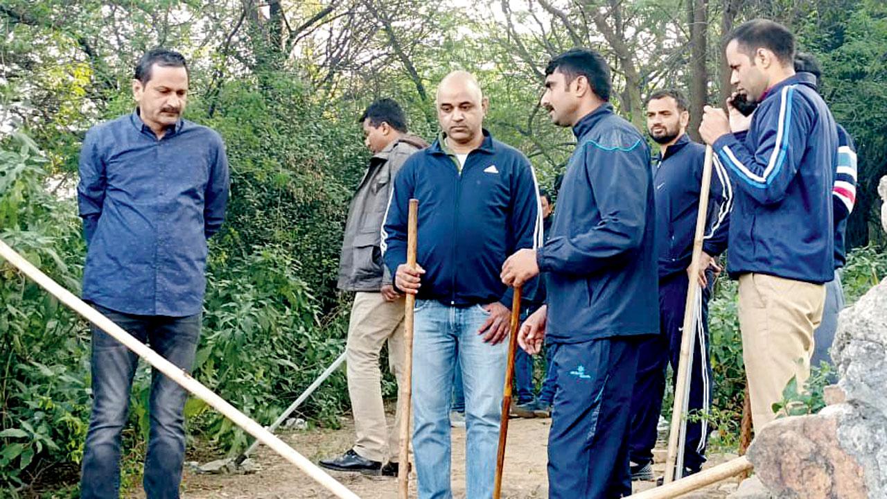 A police team conducts a search for mortal remains in Mehrauli forest