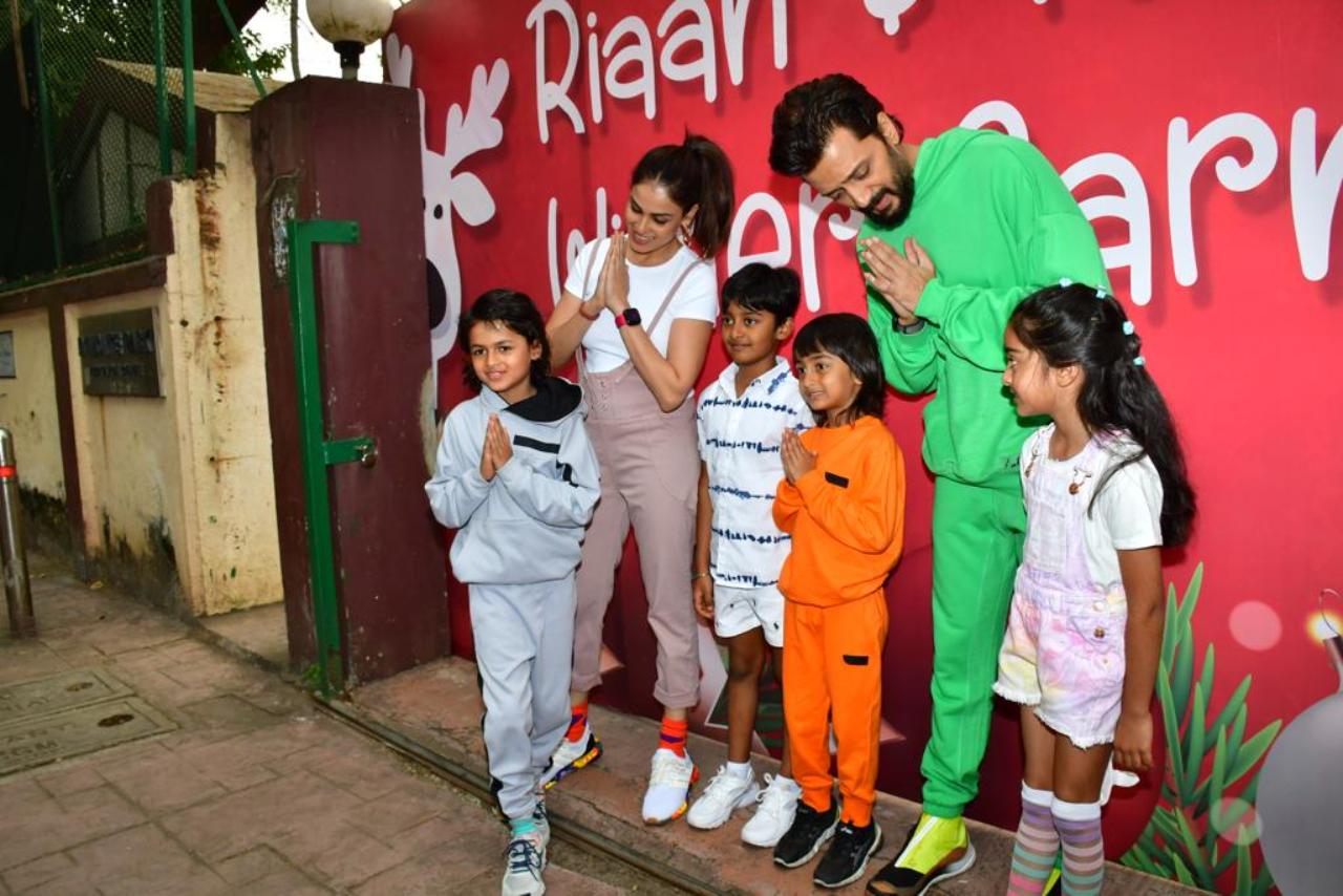 Riteish Deshmukh looked dapper in a green co-ord set, while Genelia looked cute in a white and brown jump suit as they came to celebrate their little one. The couple also posed with their sons for the paparzzi