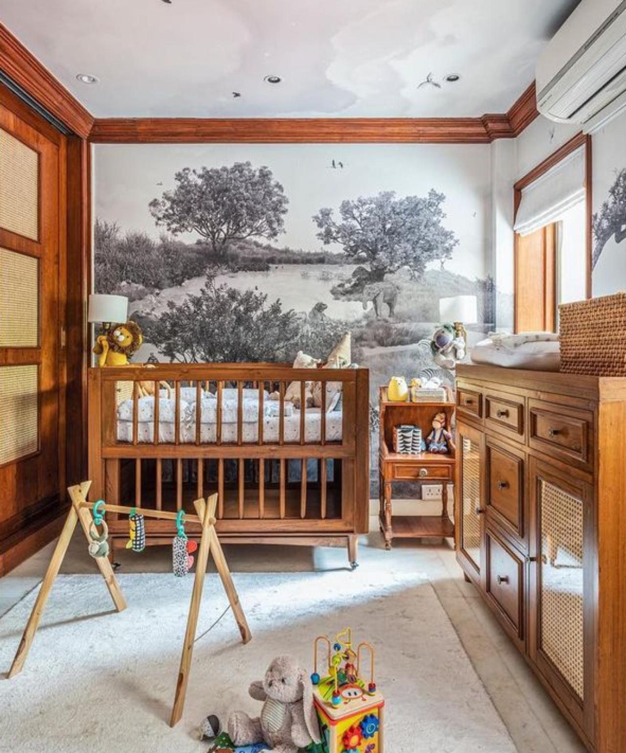 The custom made black and white safari-themed wallpaper beautifully complements the warm brown of the teak wooden furniture. And to keep the little one company, the ceiling is covered with hand-painted birds and clouds whispering lullabies to little Vayu at night