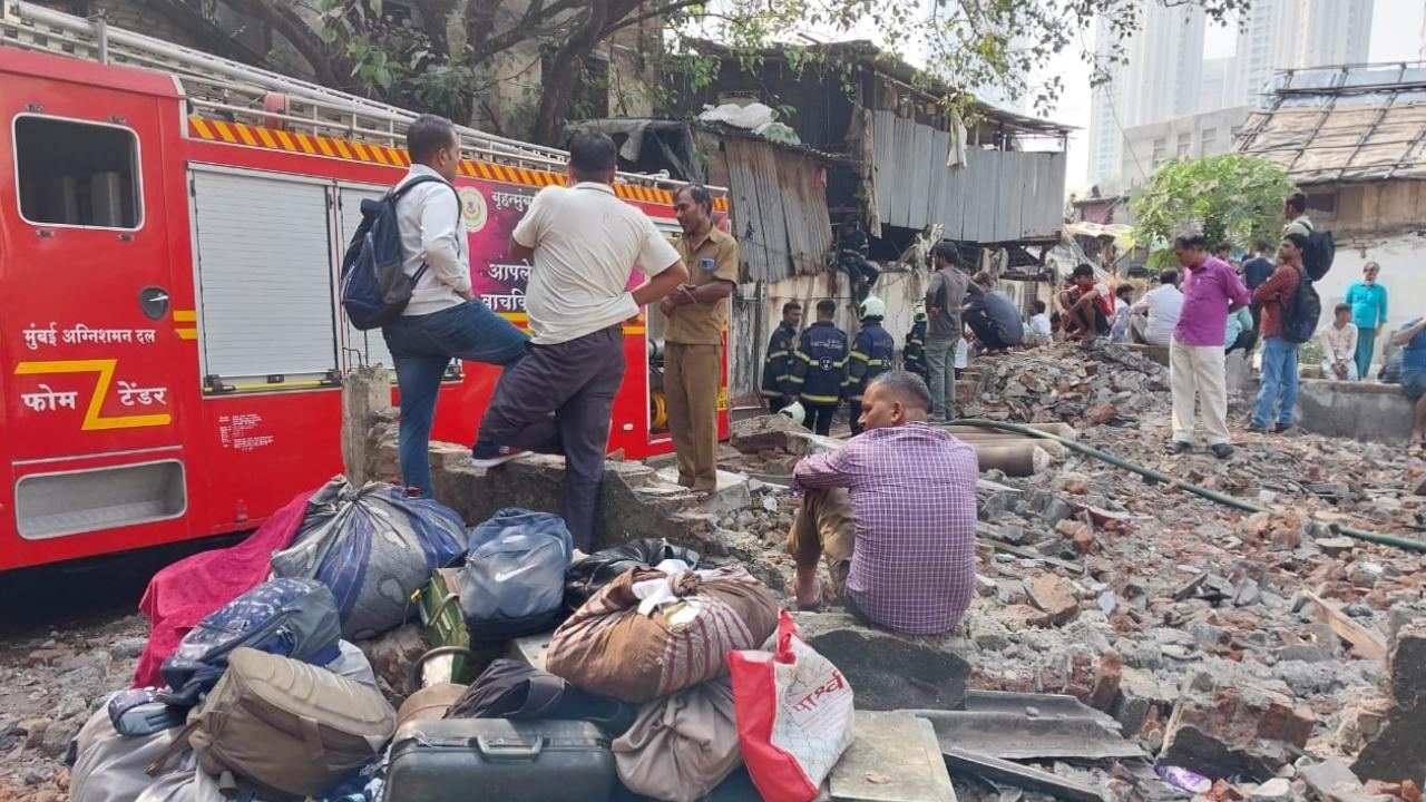 Residents wait outside the hutments amid rescue operations. Pic/Ashish Raje