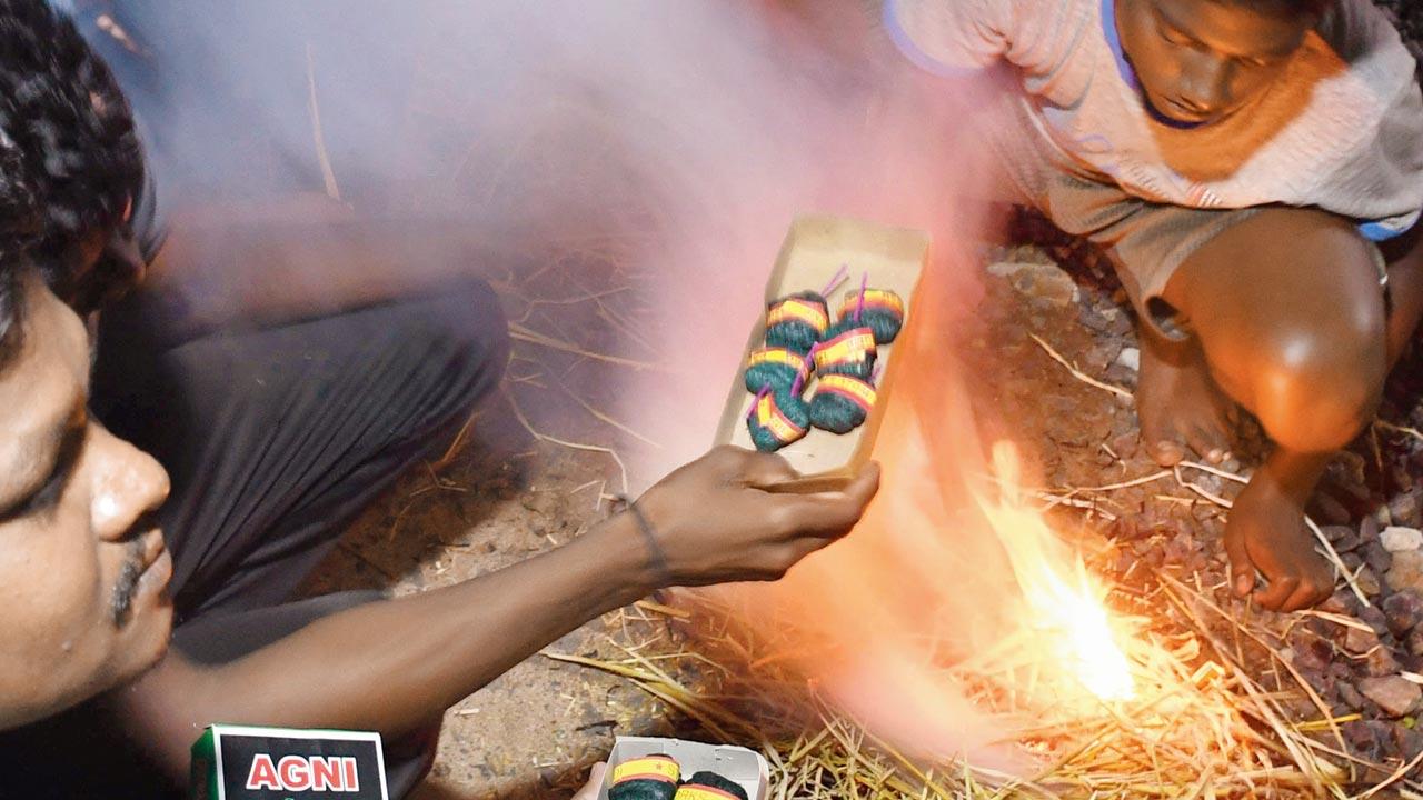 Locals from Khairi in Gondia light up crackers in the night to prevent elephants from encroaching their village