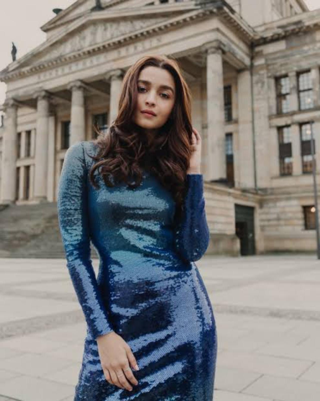 Alia Bhatt
Ever the fashion icon, Alia Bhatt brought the bling out with a blue ombre dress. She had left her hair down and had a natural makeup look which gave her a youthful aura. Alia stood out in the bright and shimmery outfit as she posed in front of a neutral background