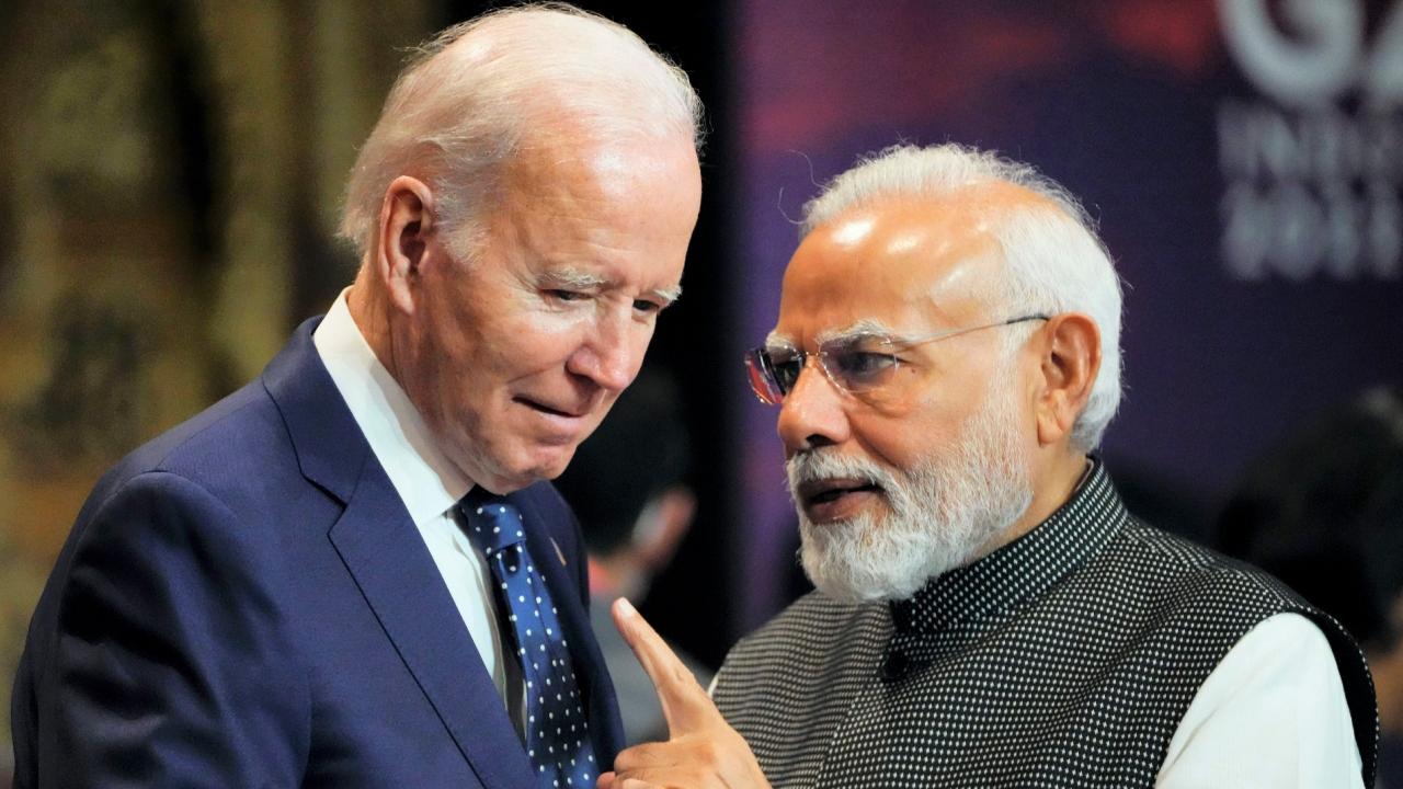 India's Prime Minister Narendra Modi talks with U.S. President Joe Biden as they arrive for the first working session of the G20 leaders summit in Nusa Dua, Bali, Indonesia