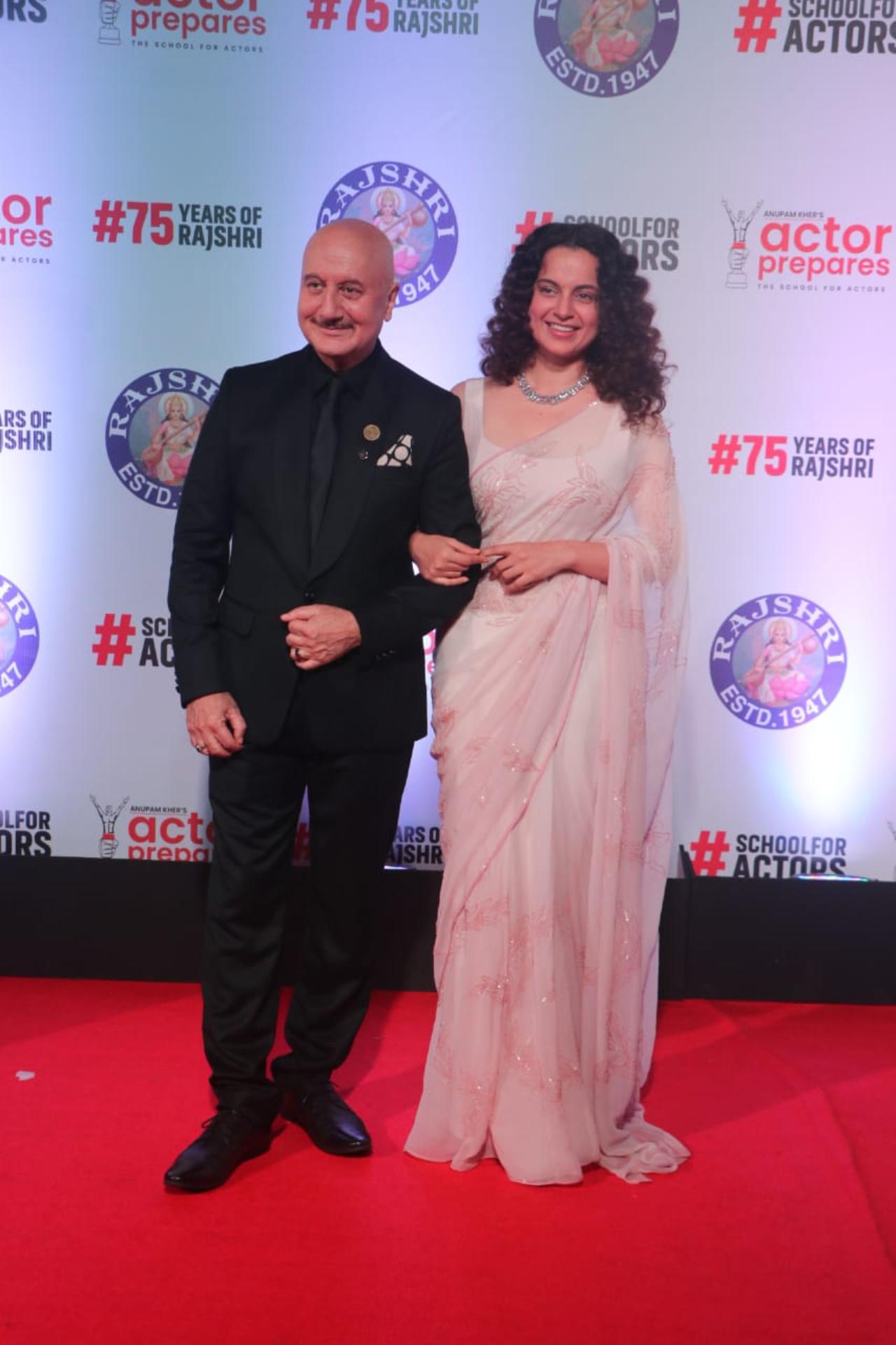 Actress Kangana Ranaut graced the red carpet in a baby pink saree. She posed with her Emergency co-star Anupam Kher for pictures