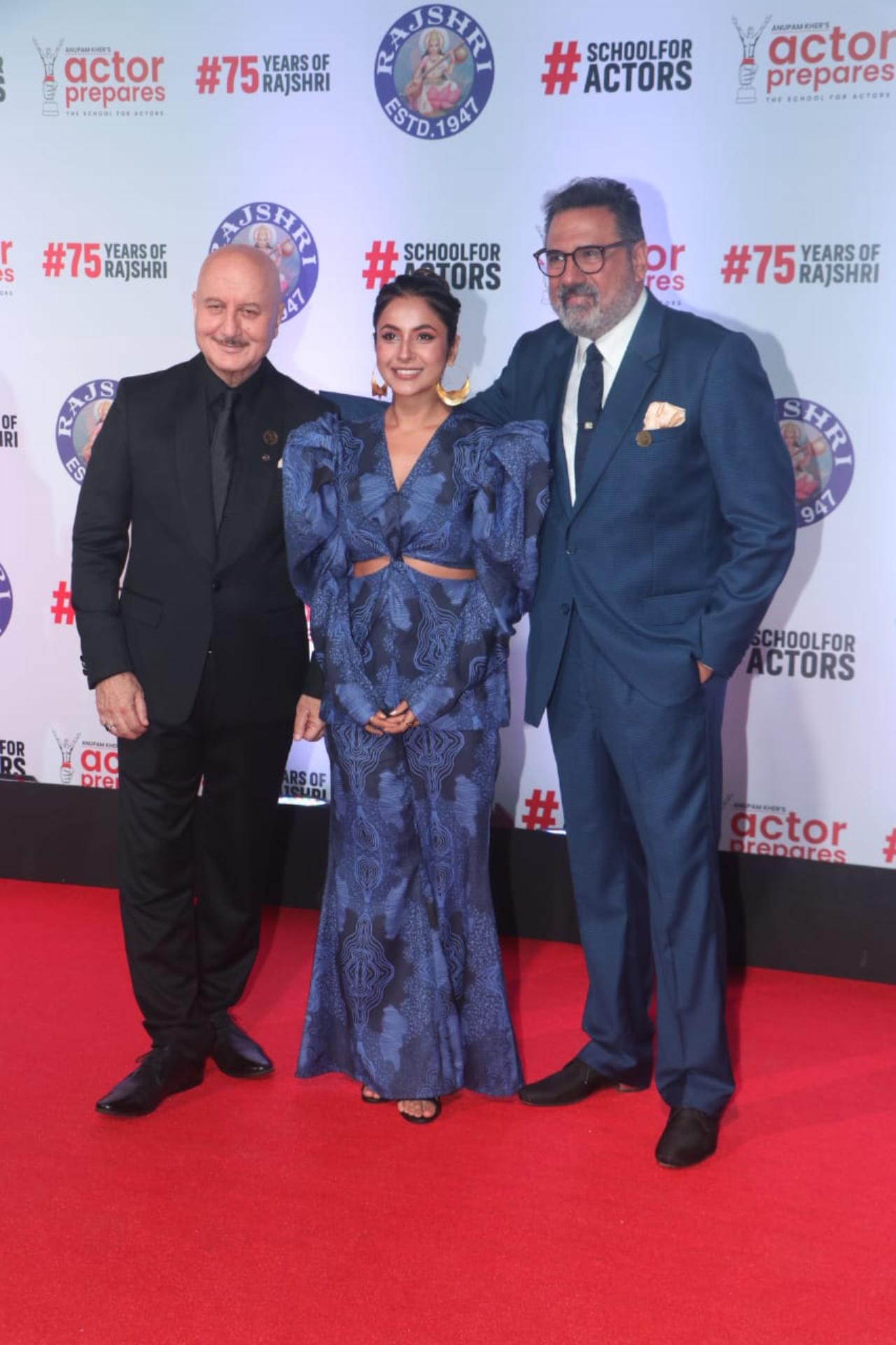 Shehnaaz Gill looked stunning in a blue flared-sleeve top paired with matching pants. She posed alongside Anupam Kher and Boman Irani on the red carpet