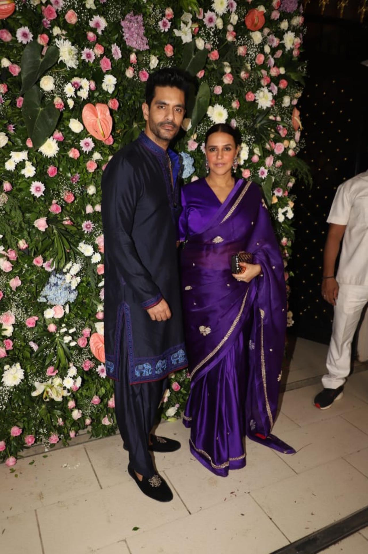 Angad Bedi looked smart in an all-black ensemble, while Neha wore a satin blue saree