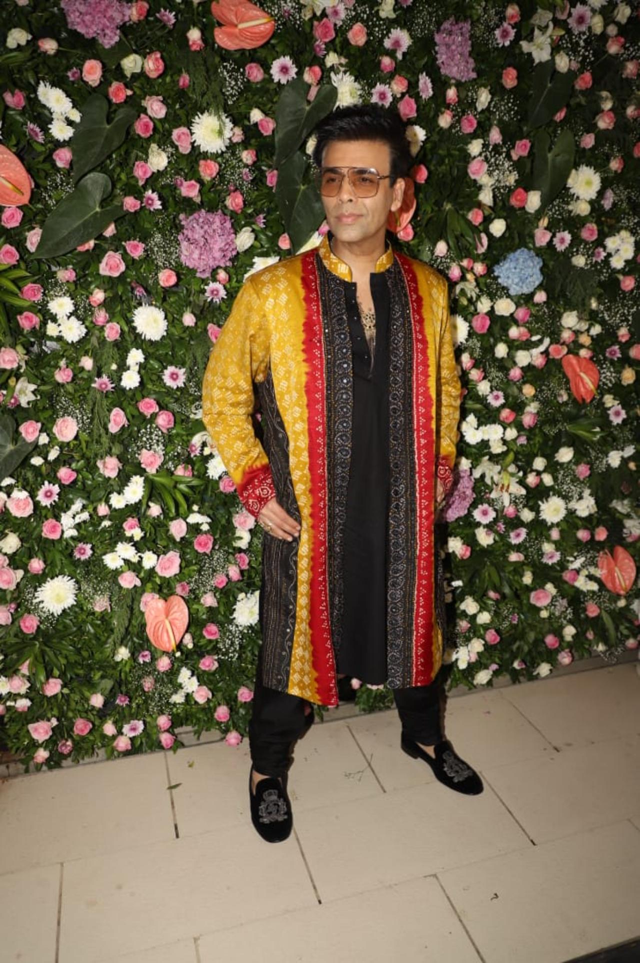 Karan Johar opted for a multi-coloured kurta and struck some cool poses for the paps before heading into the party