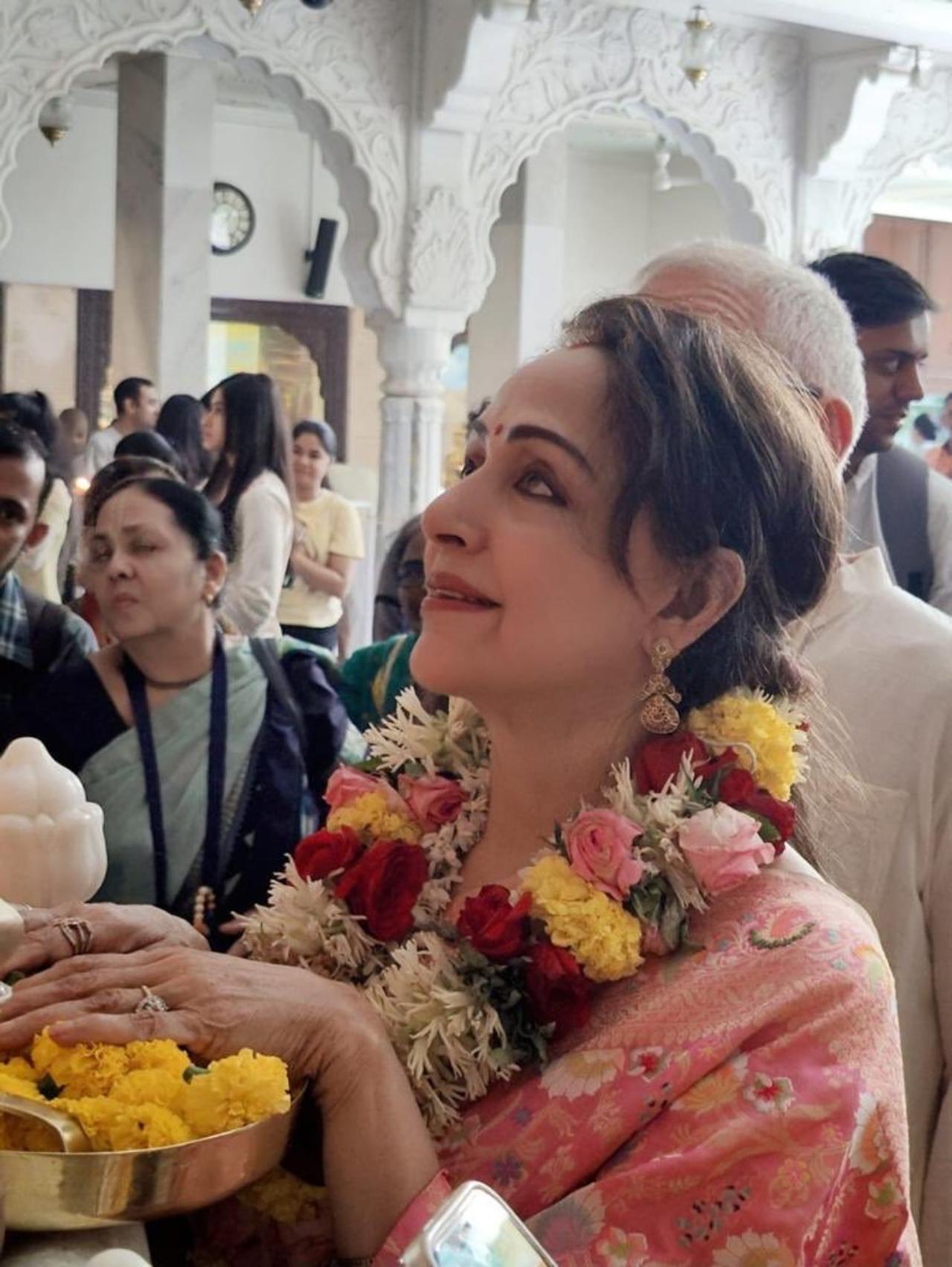 Dressed in a gorgeous baby pink saree, the actress was seen praying at the temple and greeting fans later on