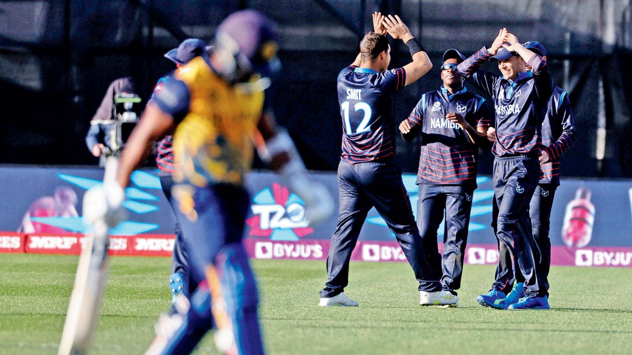 Namibia players celebrate the wicket of SL’s Chamika Karunaratne