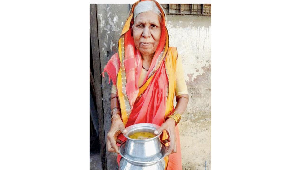 An elderly woman receives food from Roti Foundation, a hunger relief organisation started under the mentorship of former state Director General of Police D Sivanandhan