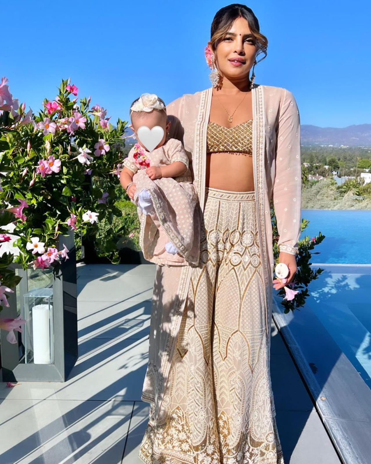 Priyanka also shared a picture of her holding her little one while posing by the pool side. For the festivities, the family twinned in ivory coloured traditional attires