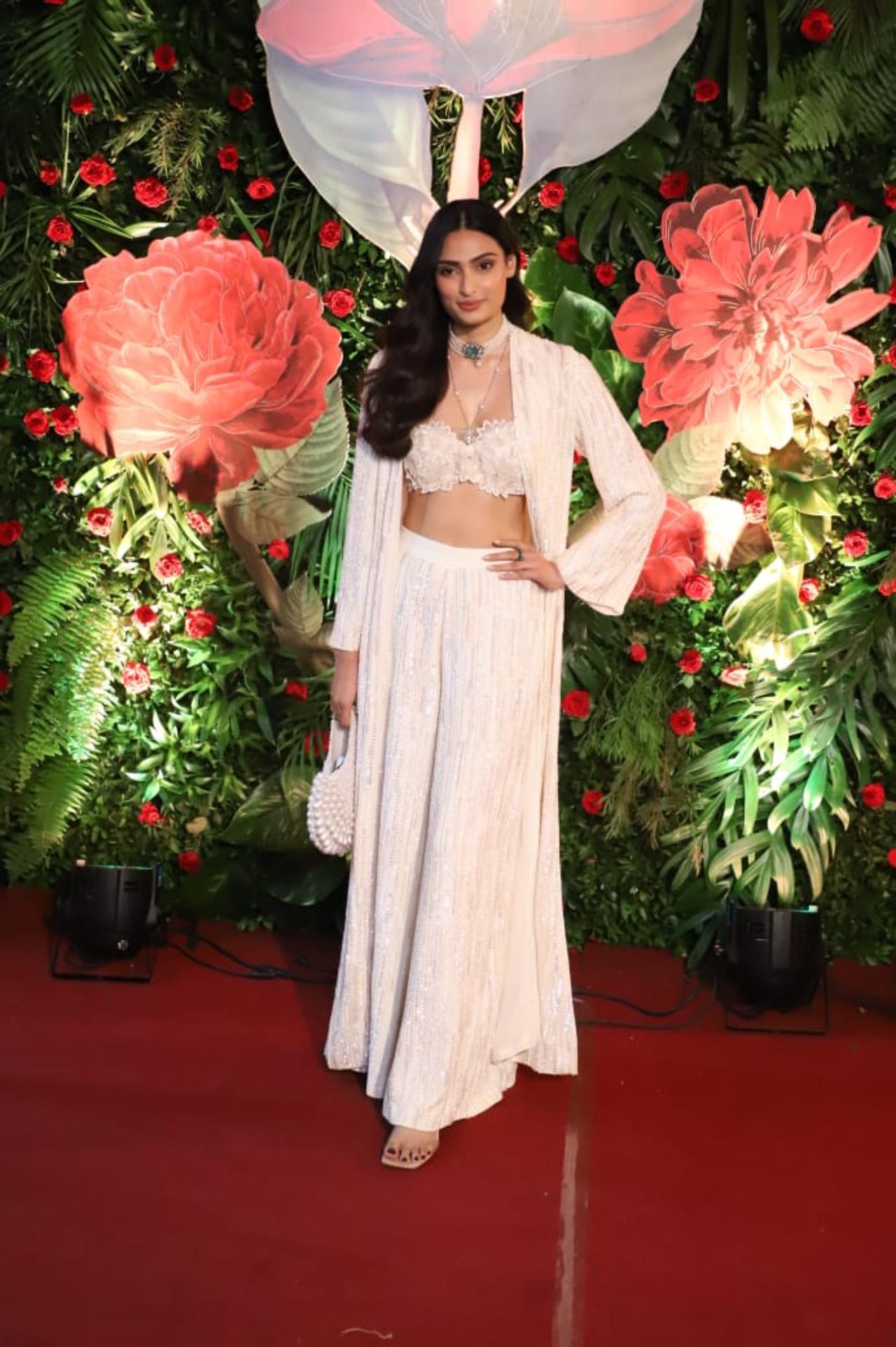 Athiya Shetty opted for an Indo-western look in all-white ensemble including a bralette, an overcoat and flared bottoms