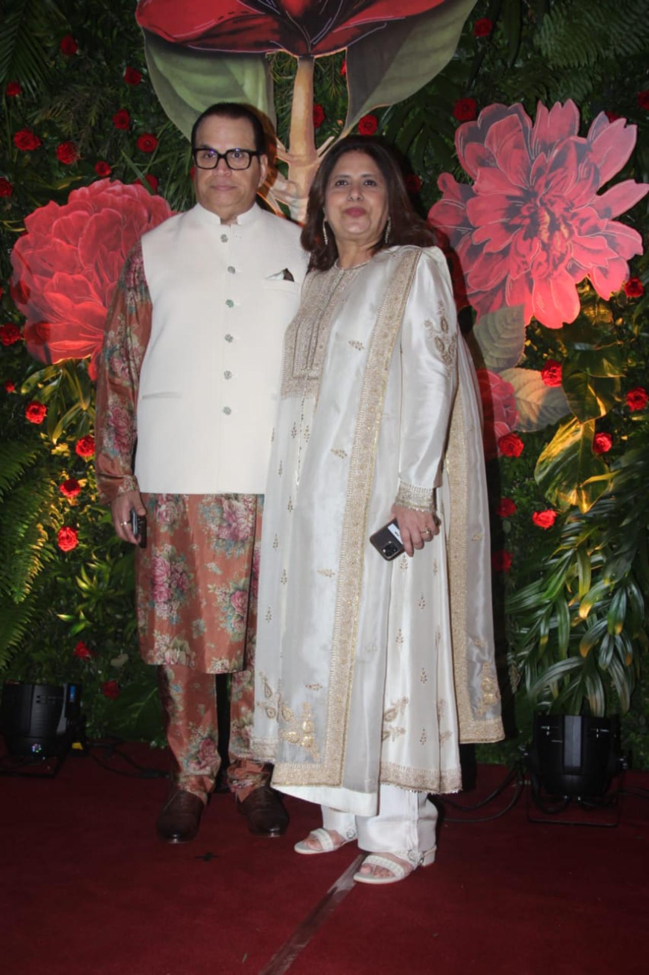 Hosts Ramesh Taurani and Varsha Taurani pose for the paparazzi