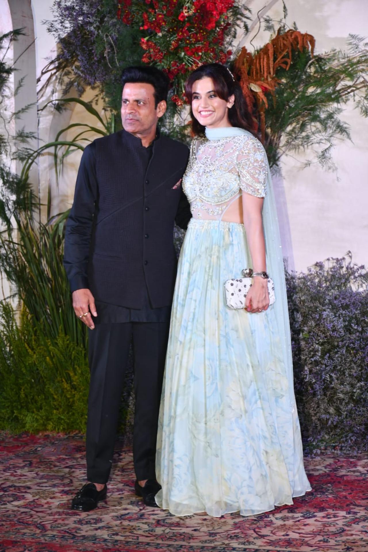 Manoj Bajpayee was wearing a black outfit which included a black shirt, trousers and jacket. Taapsee Pannu looked breathtaking in her icy blue traditional attire