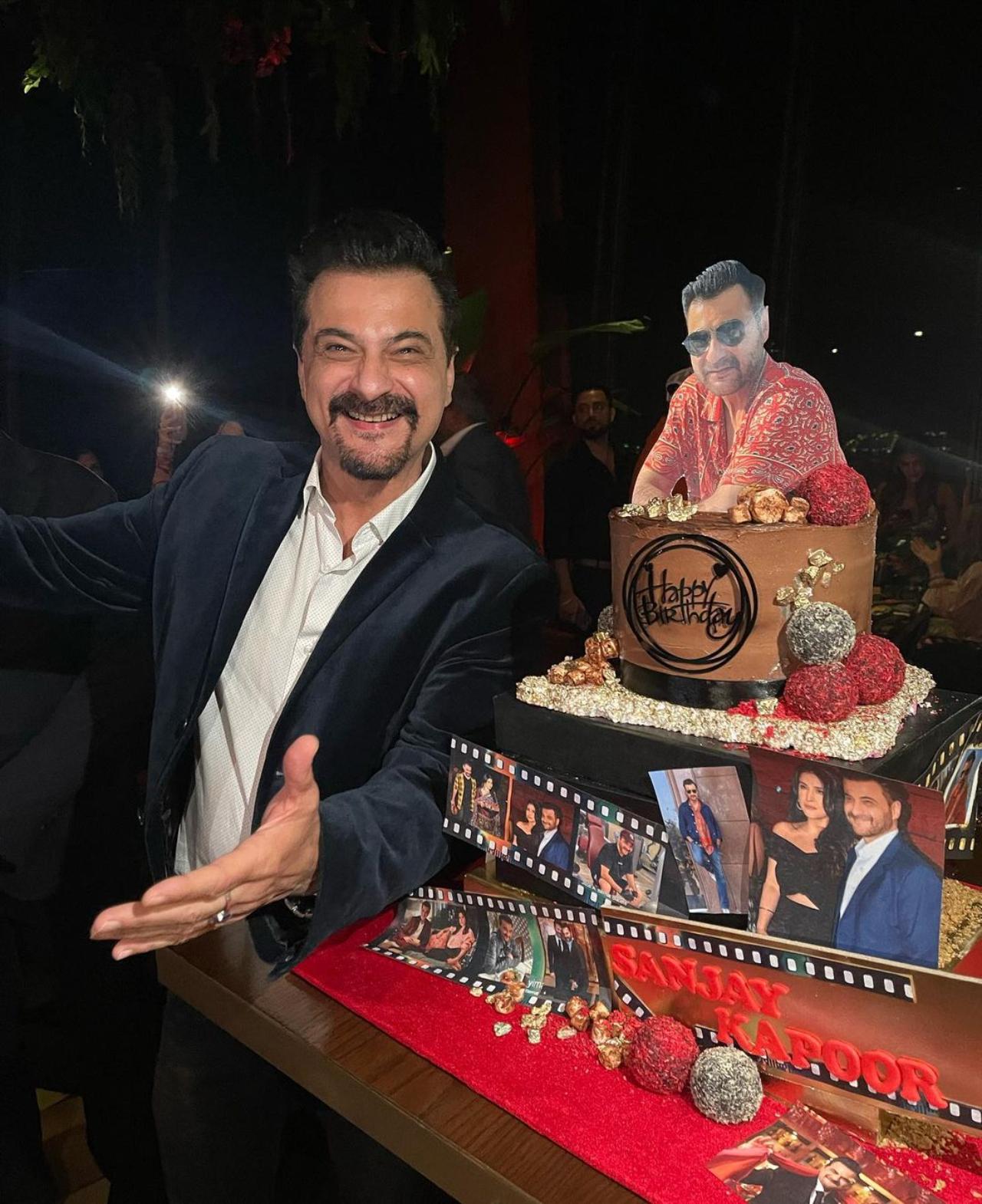 Sanjay was seen posing with his yummy and designed cake with family pictures