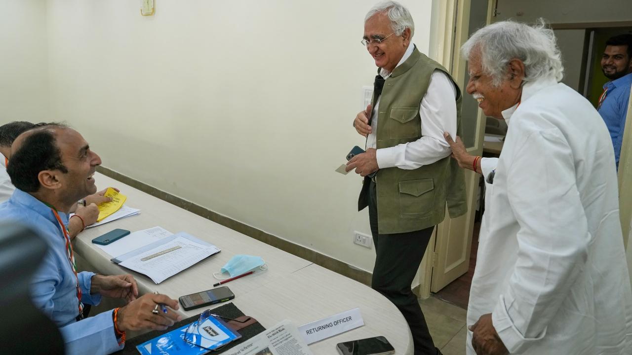Congress' central election authority chairman Madhusudan Mistry with Salman Khurshid during voting for the party's presidential election at AICC headquarters.
