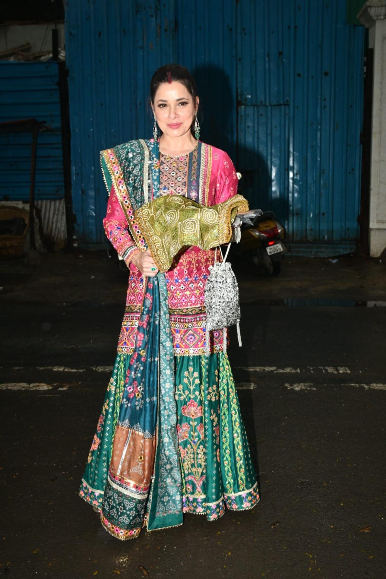 Neelam Kothari was glowing in a multi-coloured sharara as she posed for the paparazzi before heading to the Kapoor house