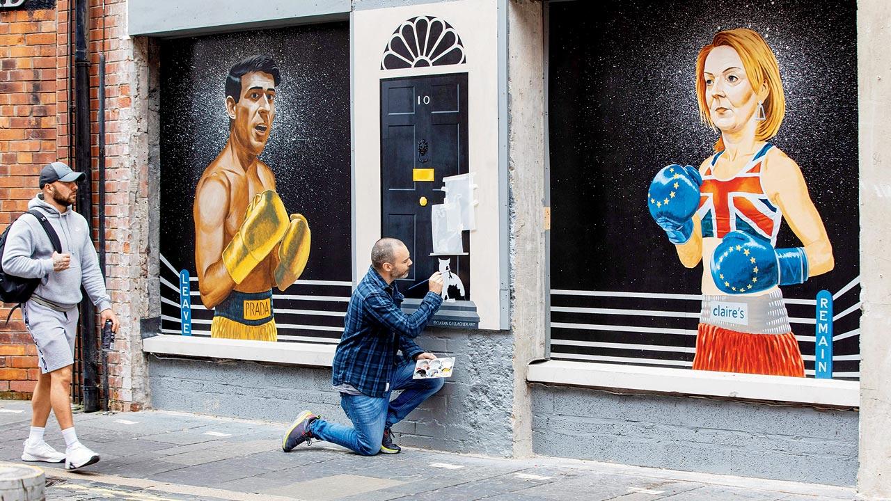 In this picture taken in September, artist Ciaran Gallagher is seen giving finishing touches to a mural in Belfast city centre, depicting contenders to Britain’s prime ministerial post, former Chancellor to the Exchequer Rishi Sunak  and British Foreign Secretary Liz Truss. While Truss won the election, she resigned 44 days later in the midst of political and economic turmoil, making her the shortest-serving PM in British history. Sunak, who amassed public nominations from nearly all the top Tory lawmakers, was appointed prime minister by King Charles on Tuesday. Pics/Getty Images
