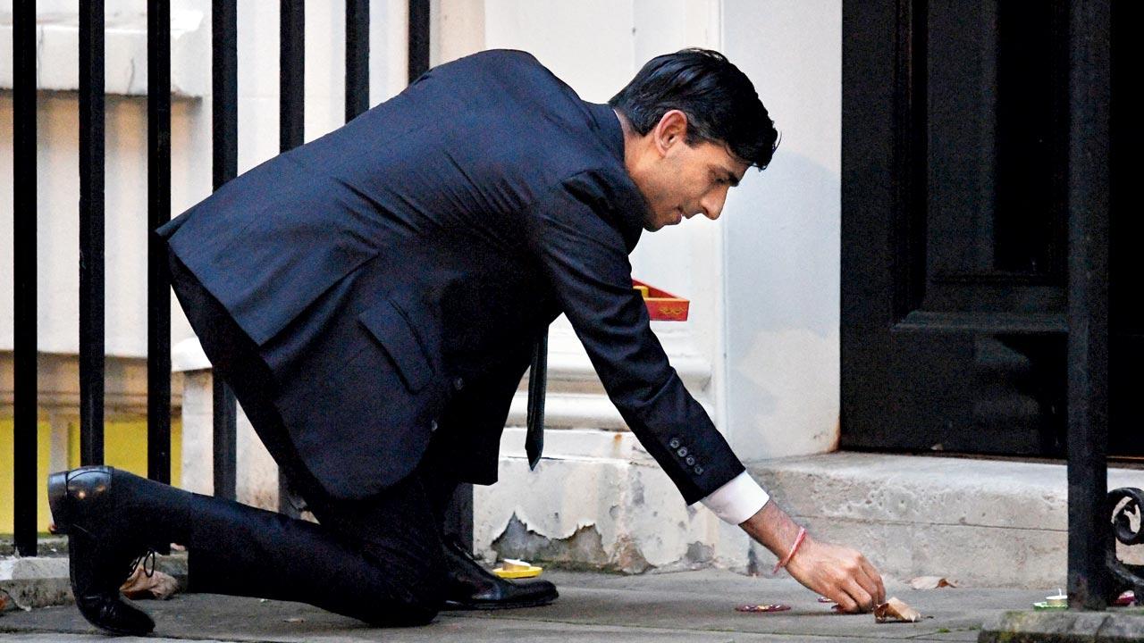 Rishi Sunak seen lighting a candle for Diwali in Downing Street on November 12, 2020 in London, England, when he was serving as Chancellor of the Exchequer. A practising Hindu, the Conservative Party leader has not shied away from wearing his religious identity on his sleeve—he was seen sporting the sacred red thread on his wrist during his first speech as PM outside his official residence