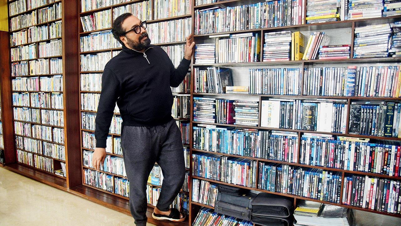 Anurag Kashyap stands beside a wall stacked with DVDs. He says he’s inspired by world cinema, Anubhuti by real life events