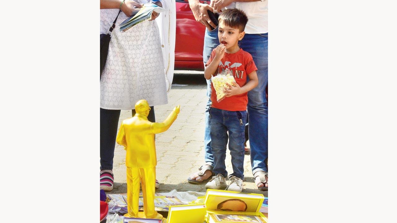 Followers of Ambedkar buy statues of Lord Buddha and Dr Ambedkar after paying their tribute on his death anniversary, at Chaityabhoomi, Shivaji Park, Dadar