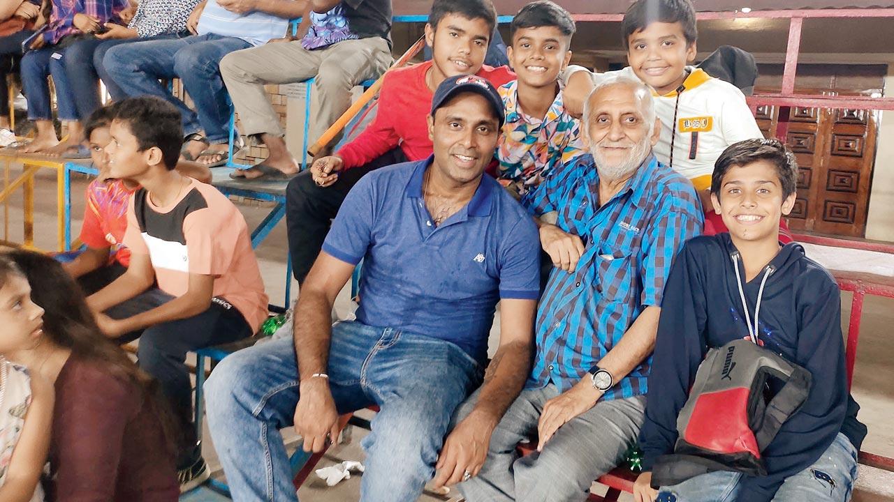 Hockey coach Marzban Patel with his students in the stands during the Mount Carmel rink hockey tournament in Bandra