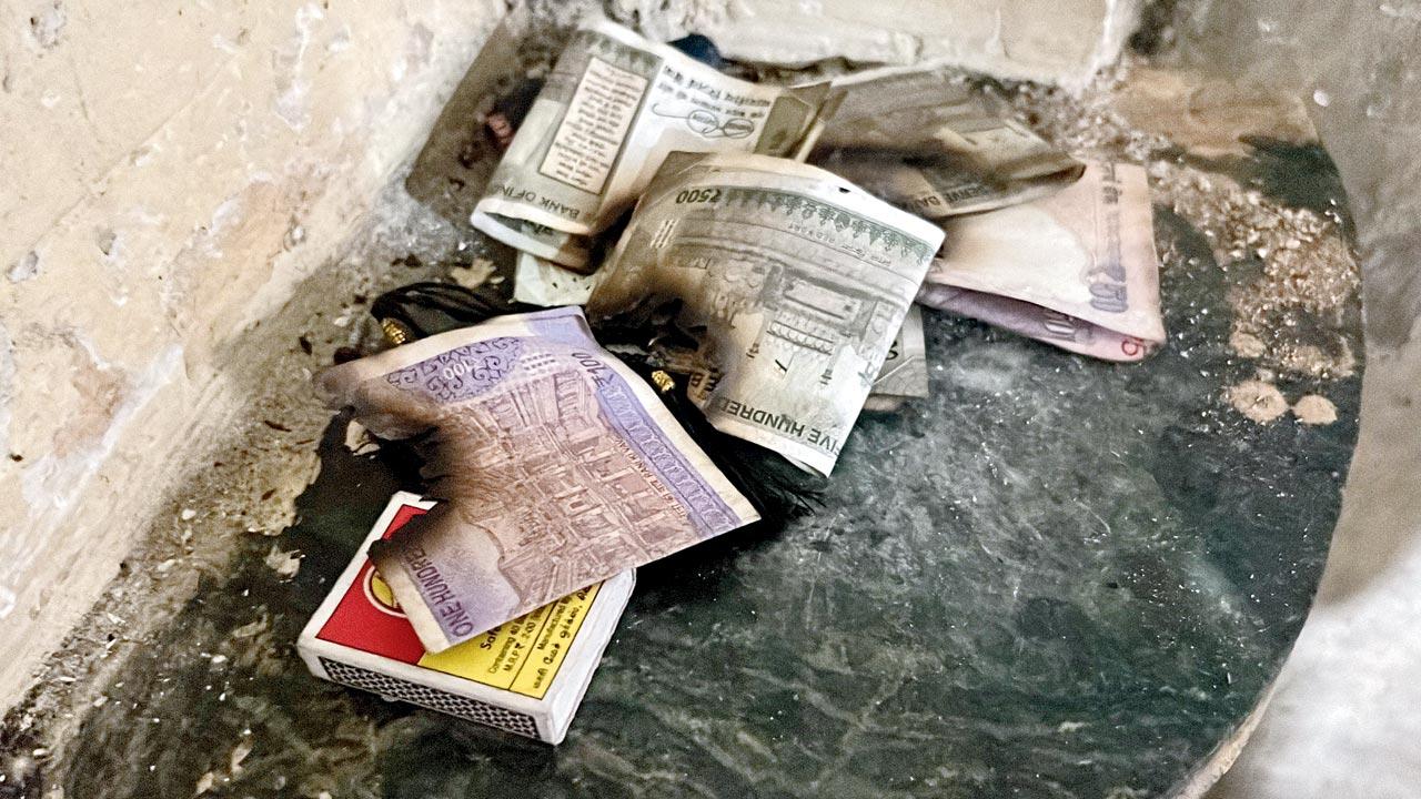 Windowpanes that were shattered due to the blast, money that was lying around in the living room, which was damaged in the blast  Shahnawaz Ansari shows the extent of damage done to his home. 