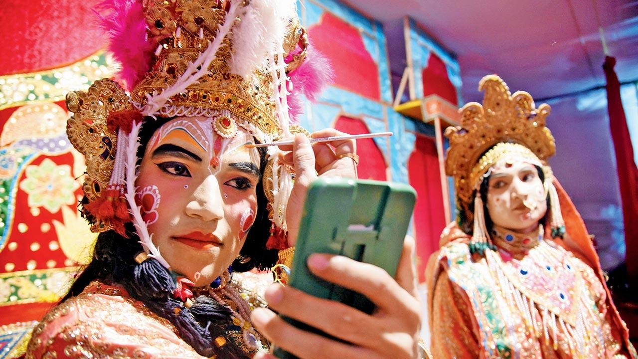 Kapil Dev Bharadwaj, leading the Braj Vrindavan Ram-Krishna Leela, gets ready to perform as Ram on stage as Sita, played by another male artiste, looks on