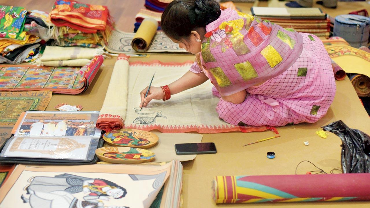 A small retail economy springs around the pandal as stalls sell traditional arts such as patchitra and handloom saris