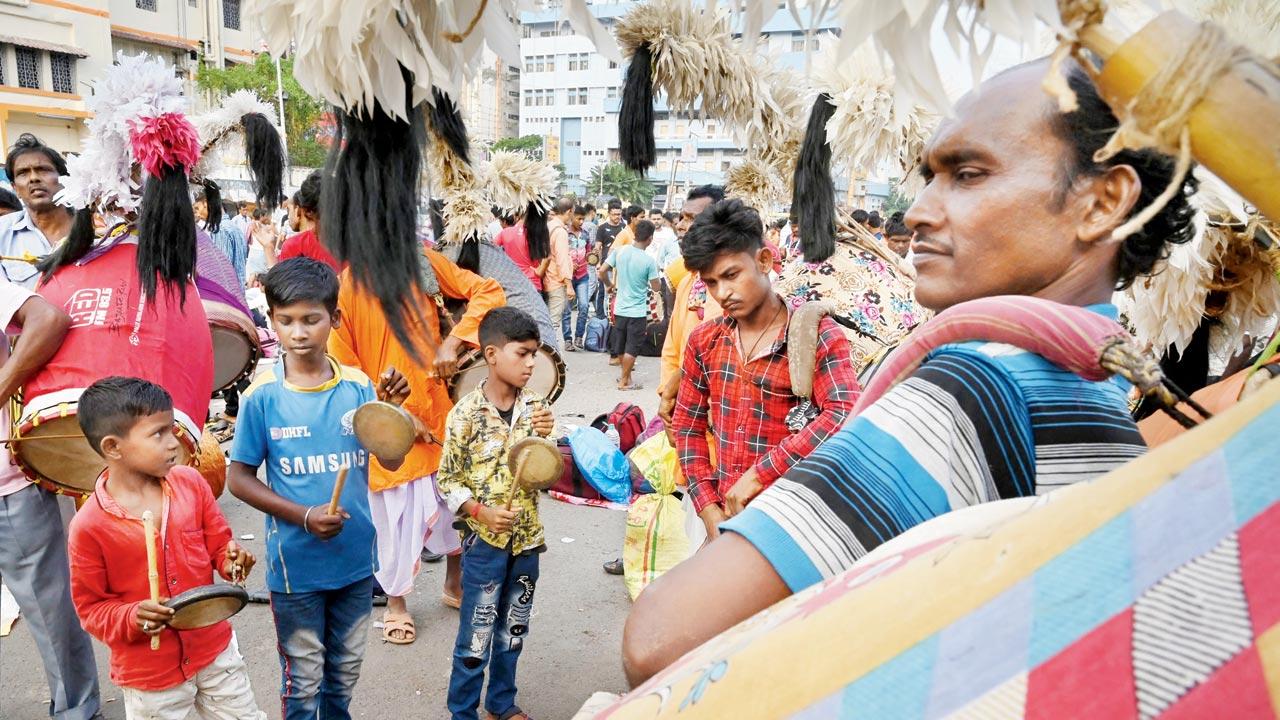 Traditional drummers wait outside a railway station in Kolkata to be hired for pujo. Performance arts such as dhak, sindur khela and dhunuchi are exclusive to pujo