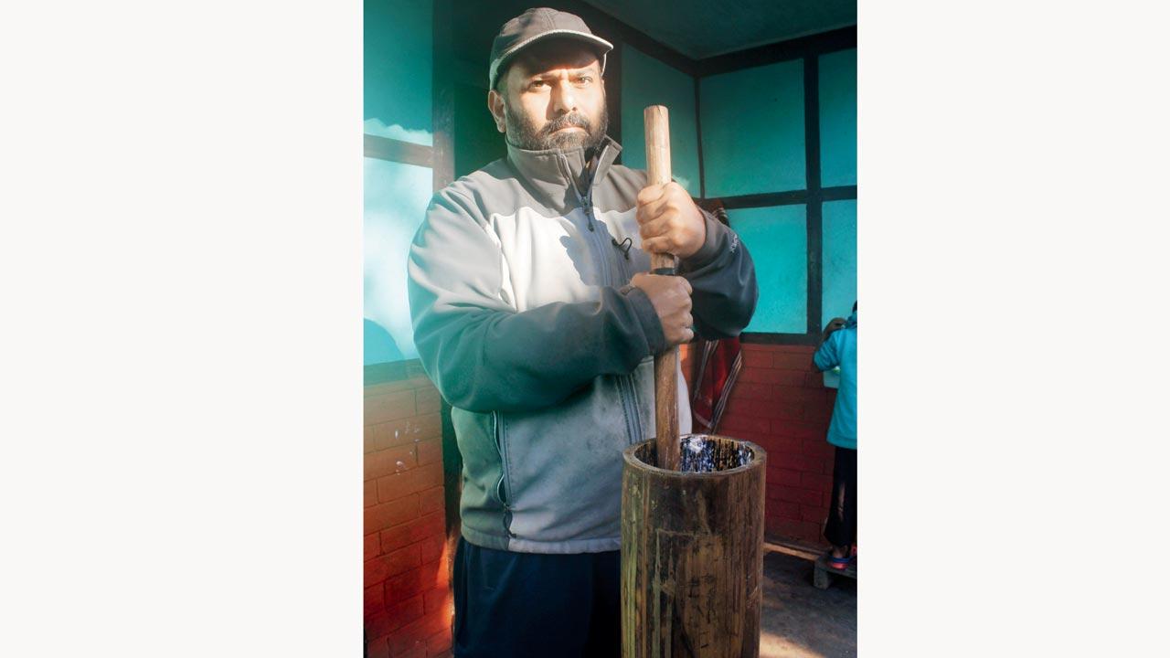 Aditya Raghavan churning butter in West Sikkim