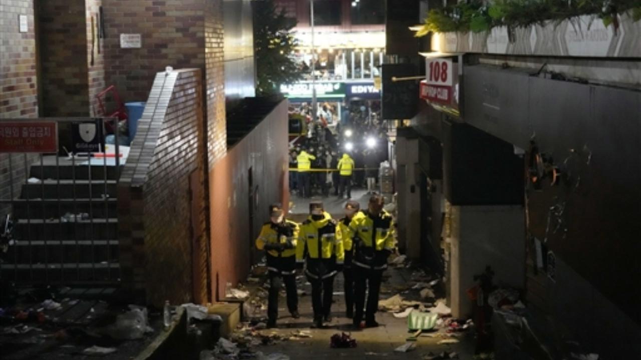 Police officers inspect the scene where people died and were injured in Seoul Pic/PTI