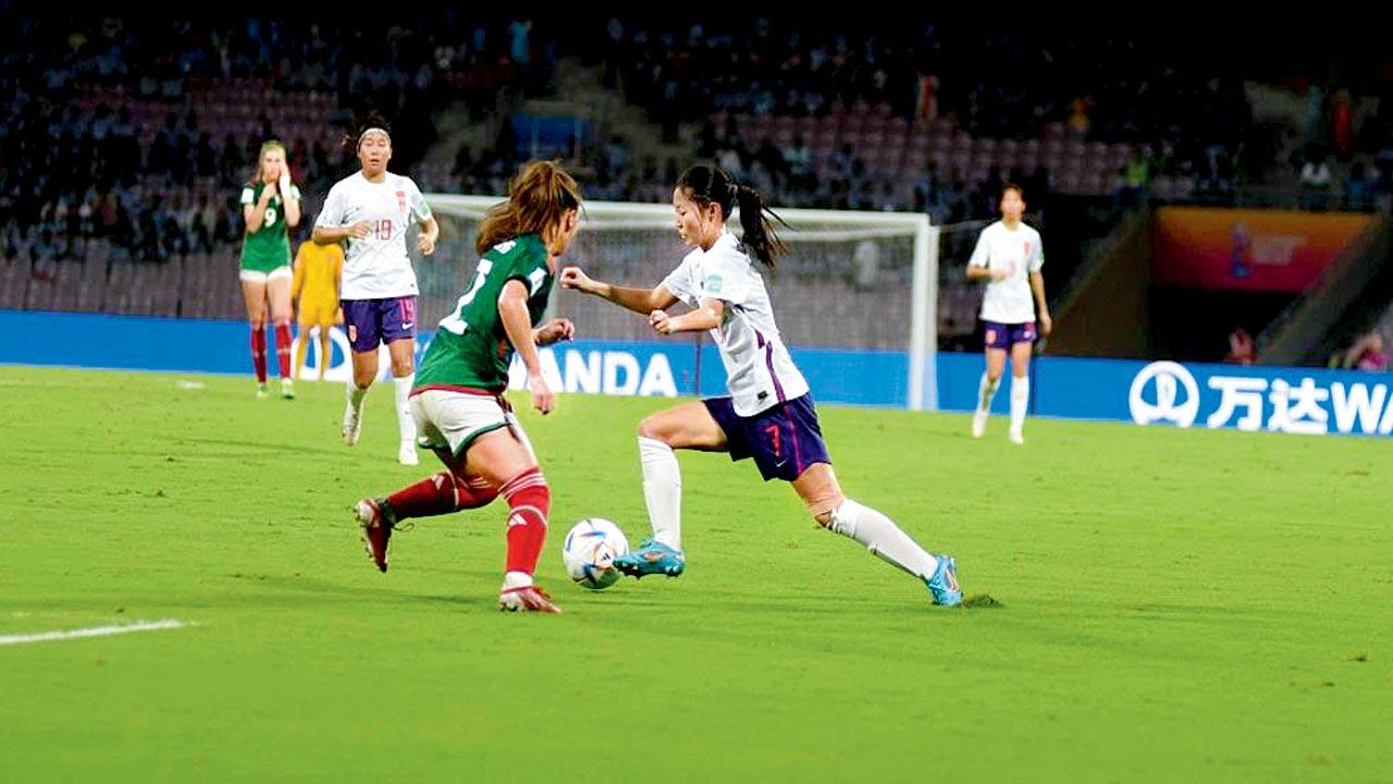 A Chinese player (right) tries to get past a Mexican defender 