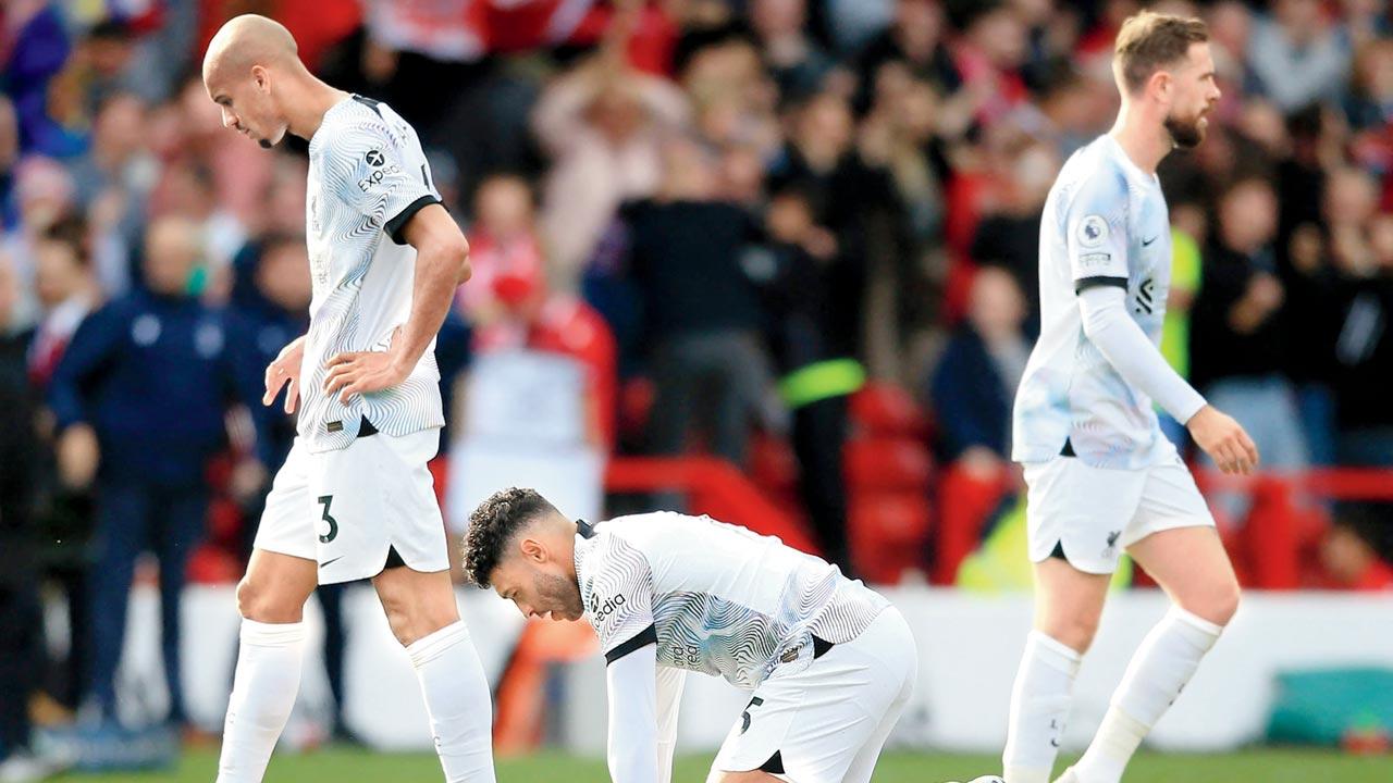 Dejected Liverpool players Fabinho (left), Alex Oxlade-Chamberlain and Jordan Henderson (right) at The City Ground in Nottingham