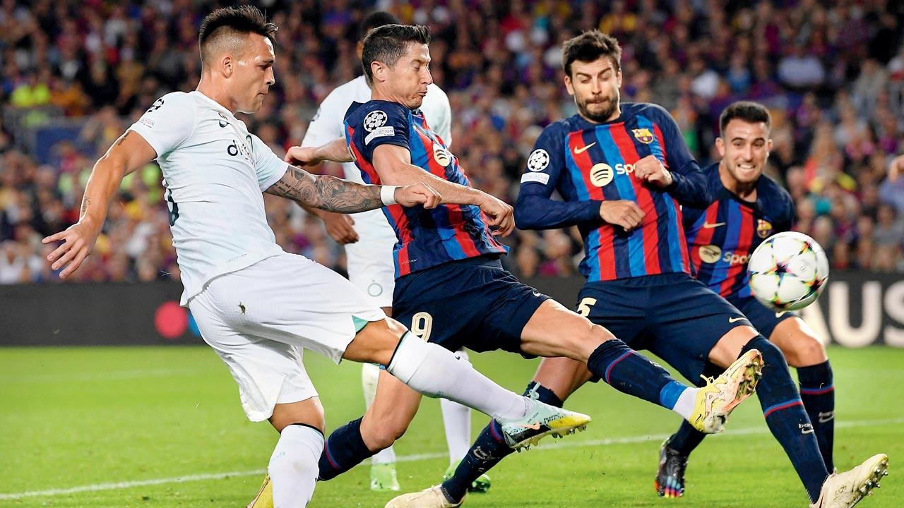 Inter’s Lautaro Martinez (left) takes a shot during the Champions League match v Barcelona on Wednesday. Pic/Getty Images