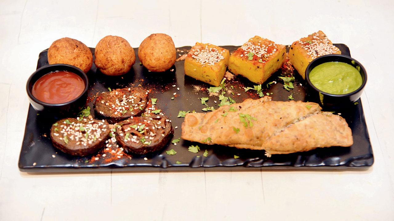 The farsan platter has two authentic Gujarati snacks, dhokla and patra, alongside a coconut pattice and paneer wrap of sorts. Pics/Sameer Markande