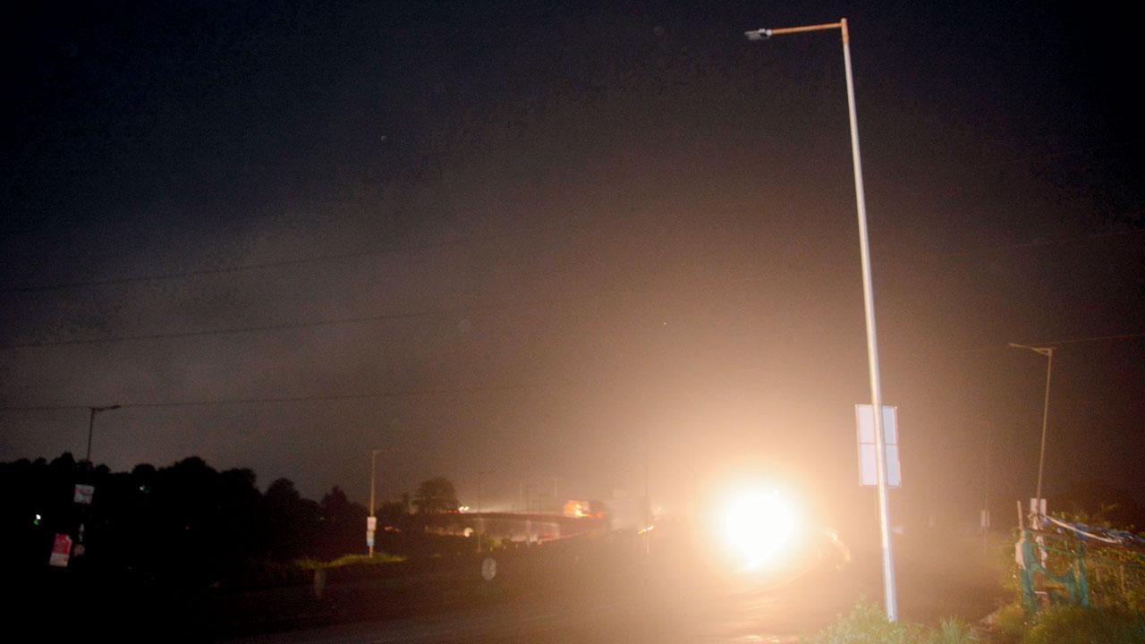 Darkness engulfs the Manor bridge on the highway
