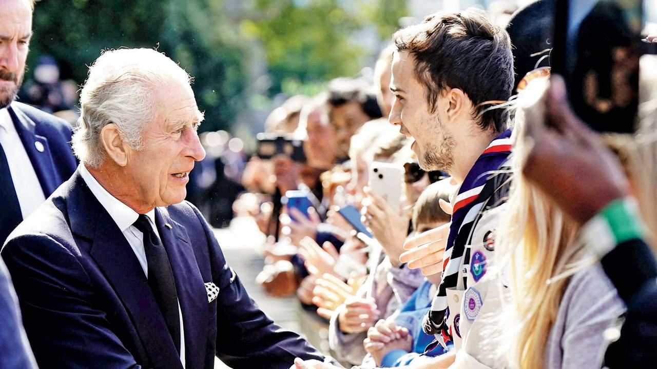 King Charles III talks with the public waiting in the queue to pay their respects to the Queen. Pic/AFP