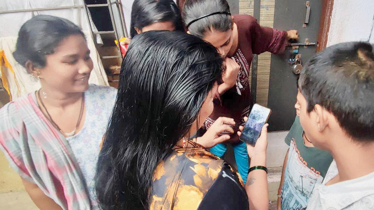 Residents watch the CCTV footage on a mobile phone