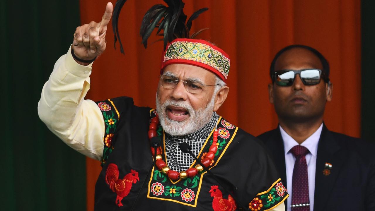Indian Prime Minister Narendra Modi gestures while addressing a Bharatiya Janata Party rally, dressed in traditional Khasi tribe attire and Garo tribe headgear, in Shillong on December 16, 2017. Photo Couetesy: AFP