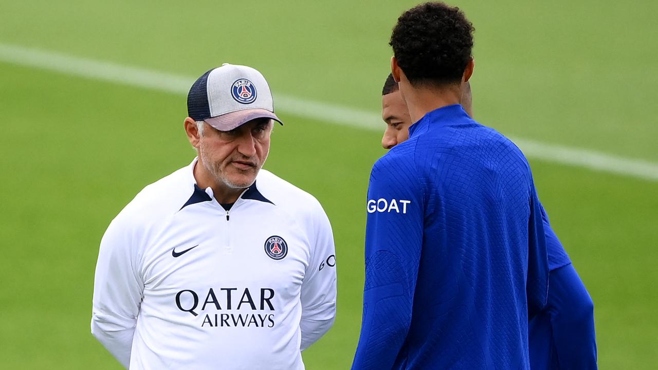 Paris Saint-Germain's French head coach Christophe Galtier (L) speaks with Paris Saint-Germain's French forward Kylian Mbappe (C) during a training session at the club's training ground in Saint-Germain-en-Laye