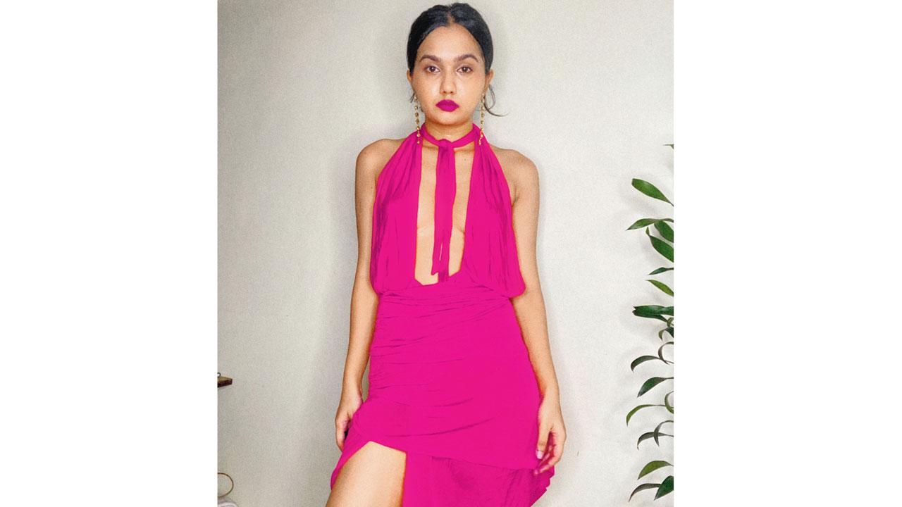 Rachel D’cruz in a bright pink outfit and bold pink lips