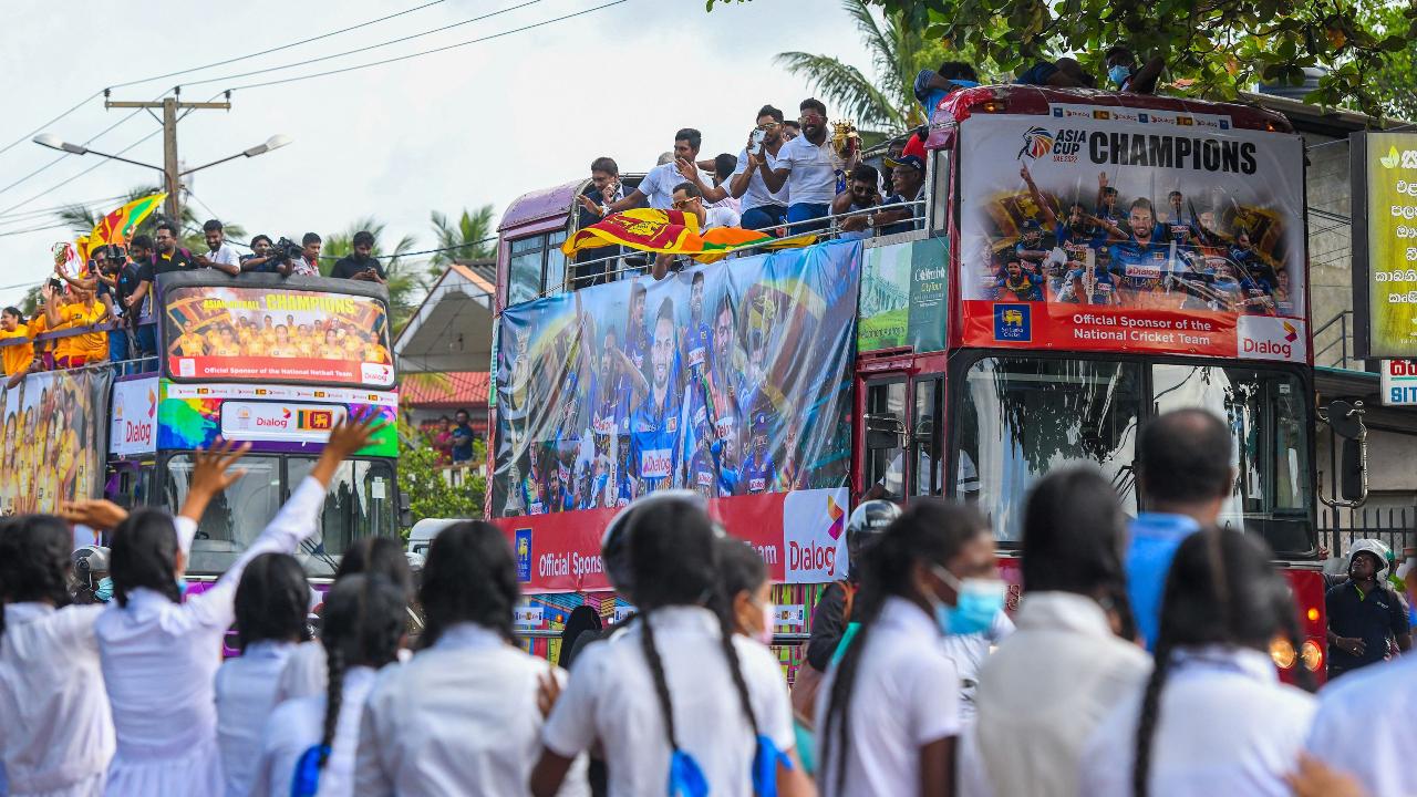Sri Lankan fans gather around their team's bus to welcome the Asia Cup 2022 final champions.