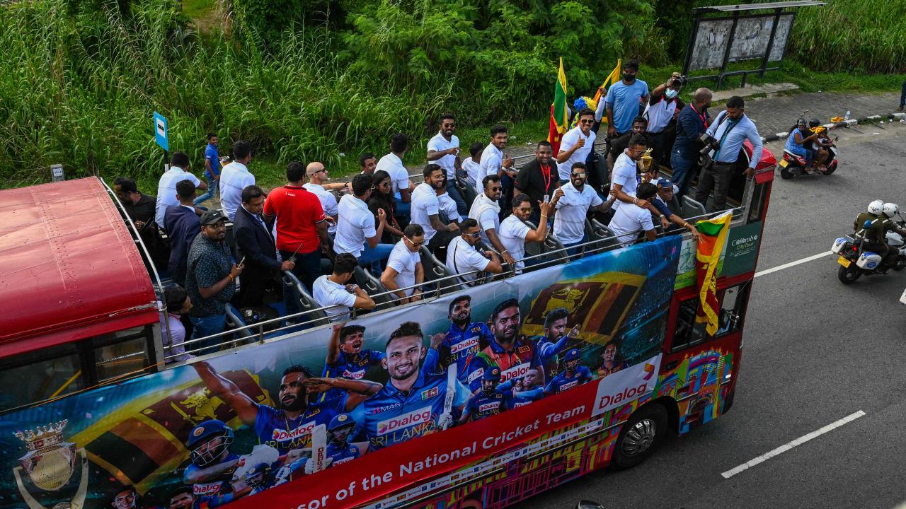 Members of the Sri Lankan cricket team travel on an open-top bus to celebrate their victory during the Asia Cup 2022 Final success over Pakistan.