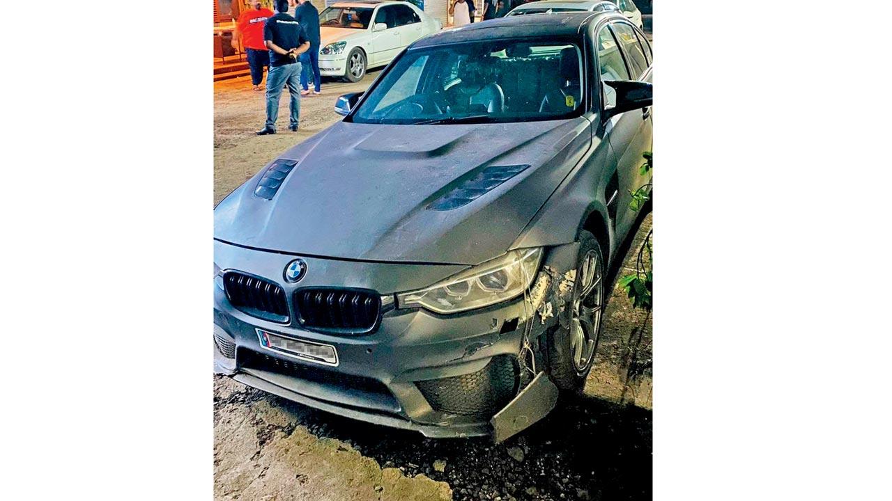 The BMW car with damages to its fender that was brought to a garage for repair, CCTV footage of the accident
